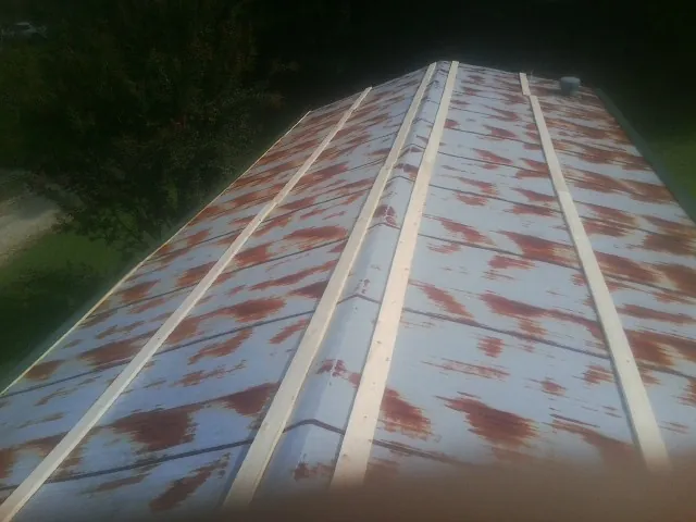 Rusted metal roof panels with new wood purlins before replacement — Storm Damage Roof Repair in Sutter by Roofing Brothers